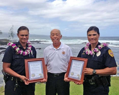 Hilo Exchange Club board member Joey Estrella presents "Officer of the Month" awards to Charrise Wakita and Earl Haskell 